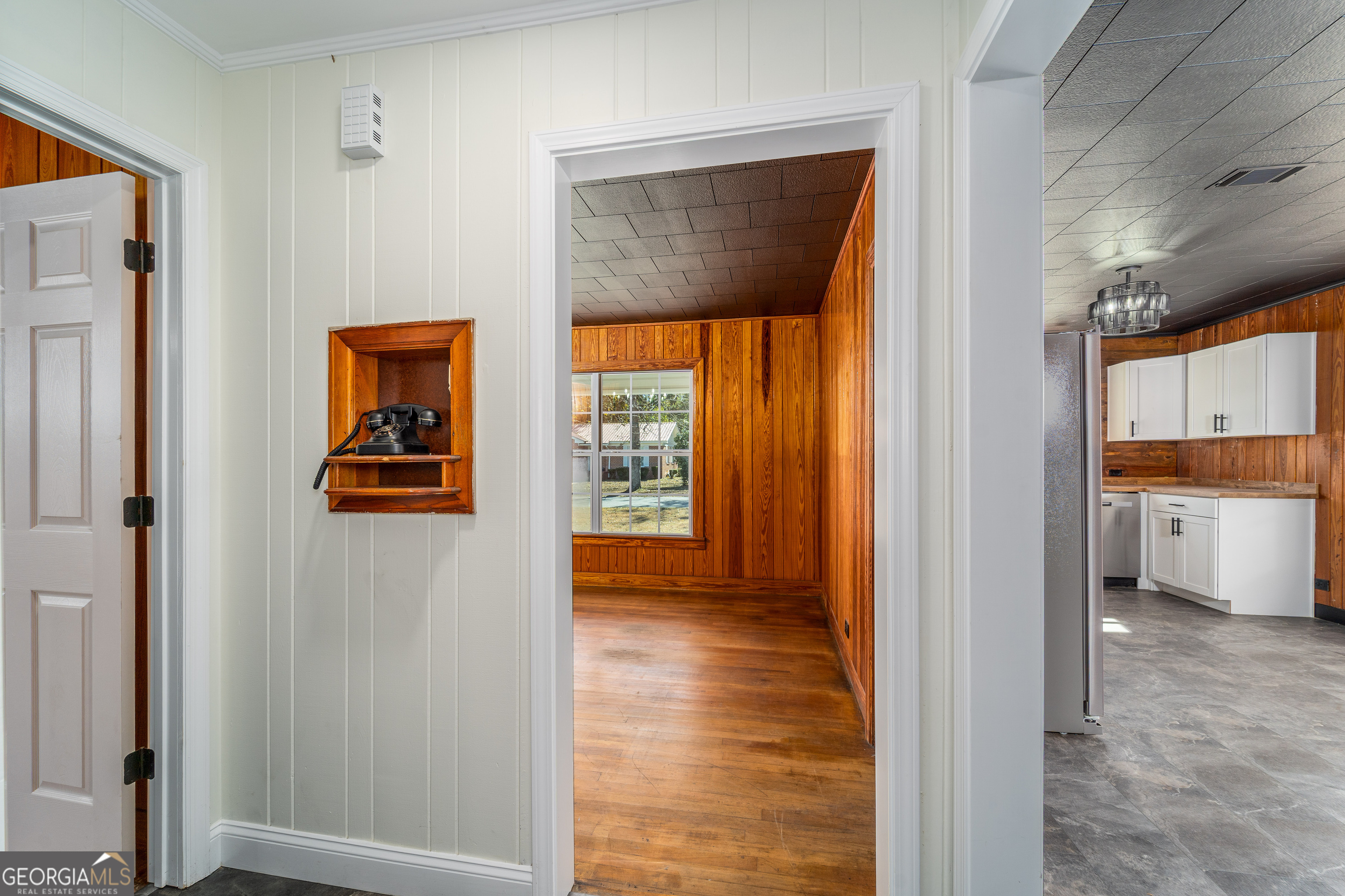 322 McGregor Street Blackshear, GA 31516 - Photo 23 of 30 a view of a hallway with wooden floor and a living room