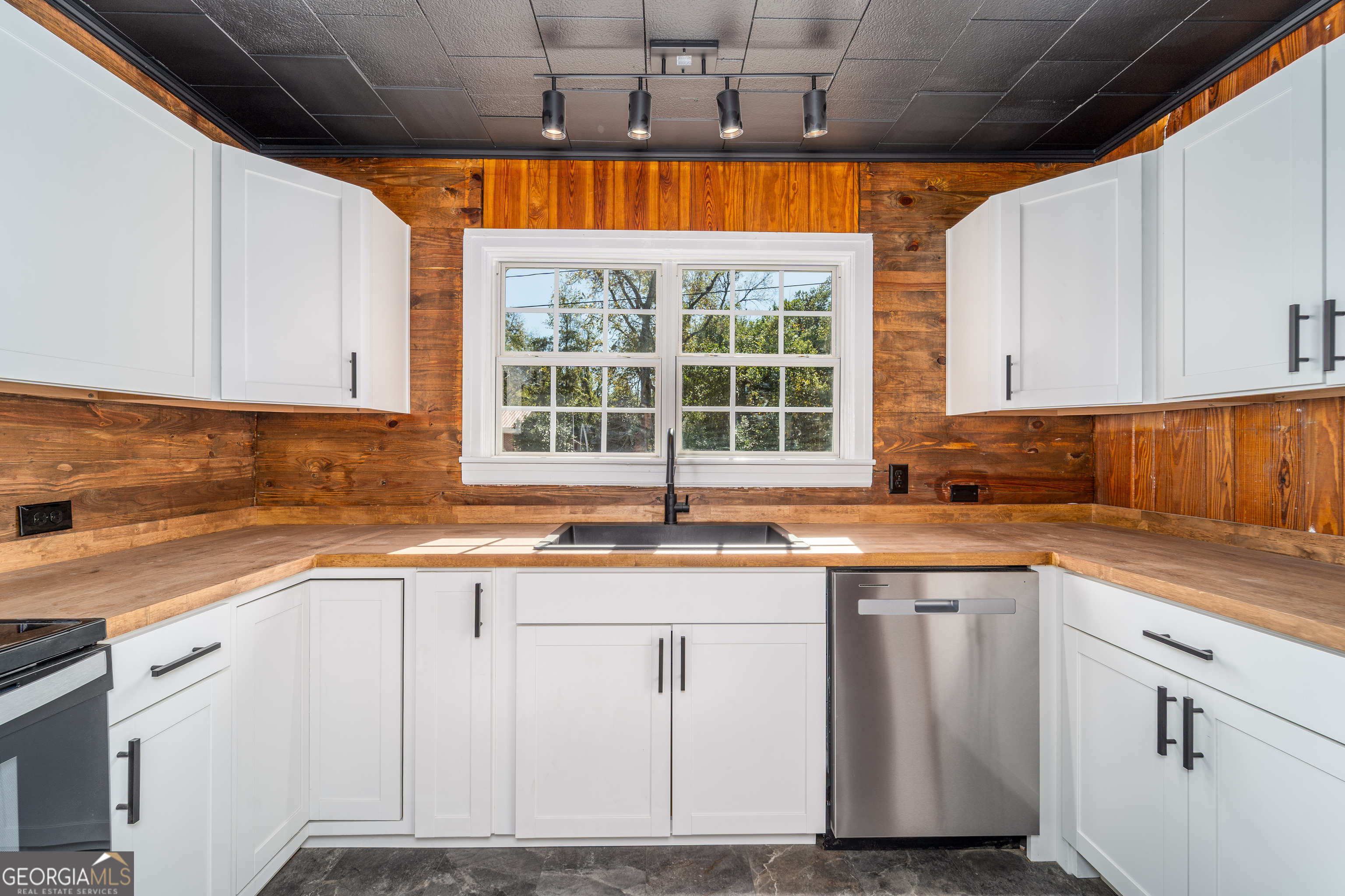 322 McGregor Street Blackshear, GA 31516 - Photo 7 of 30 a kitchen with granite countertop white cabinets and a window