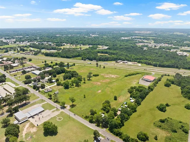 an aerial view of a residential houses with outdoor space
