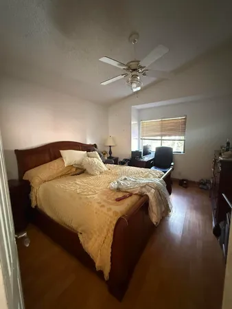 a bedroom with a bed and window