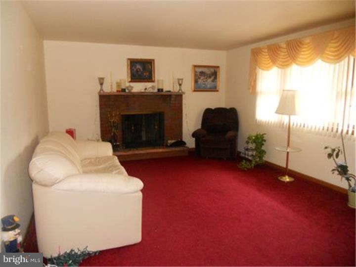 2762 Garwood Road Sicklerville, NJ 08081 - Photo 2 of 12 a living room with furniture and a fireplace
