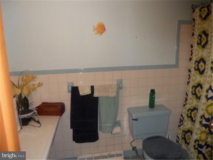 2762 Garwood Road Sicklerville, NJ 08081 - Photo 7 of 12 a bathroom with a toilet and a shower curtain