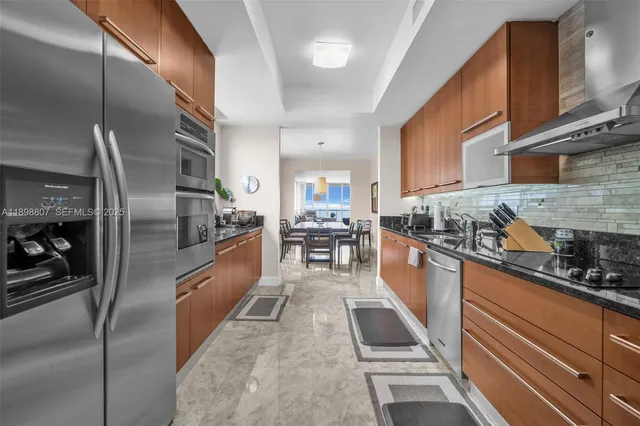 a large kitchen with stainless steel appliances kitchen island granite countertop a large counter top stainless steel appliances and cabinets