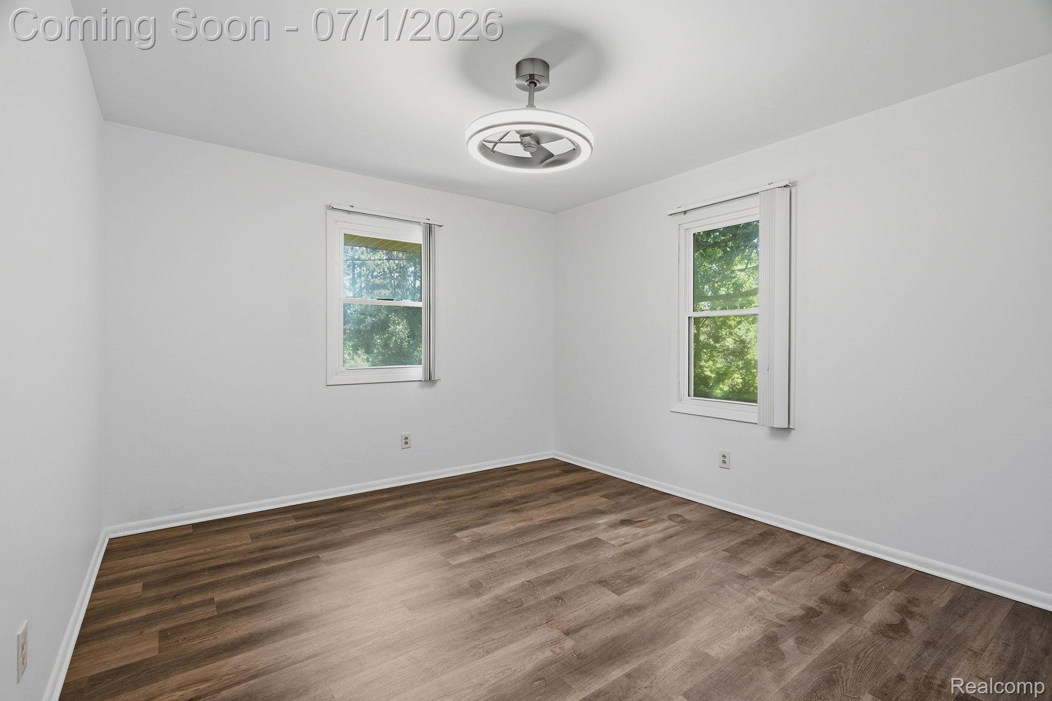 4762 Lonsberry Road Columbiaville, MI 48421 - Photo 23 of 36 Bright interior space featuring wood-finish flooring, white walls, and a modern ceiling fan with integrated lighting