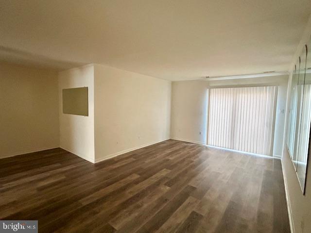 10 Kettle Court, Unit 76F Windsor Mill, MD 21244 - Photo 4 of 11 a view of an empty room with wooden floor and a window