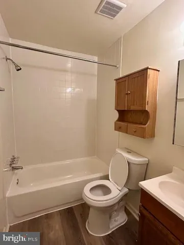 a bathroom with a toilet a sink and bathtub