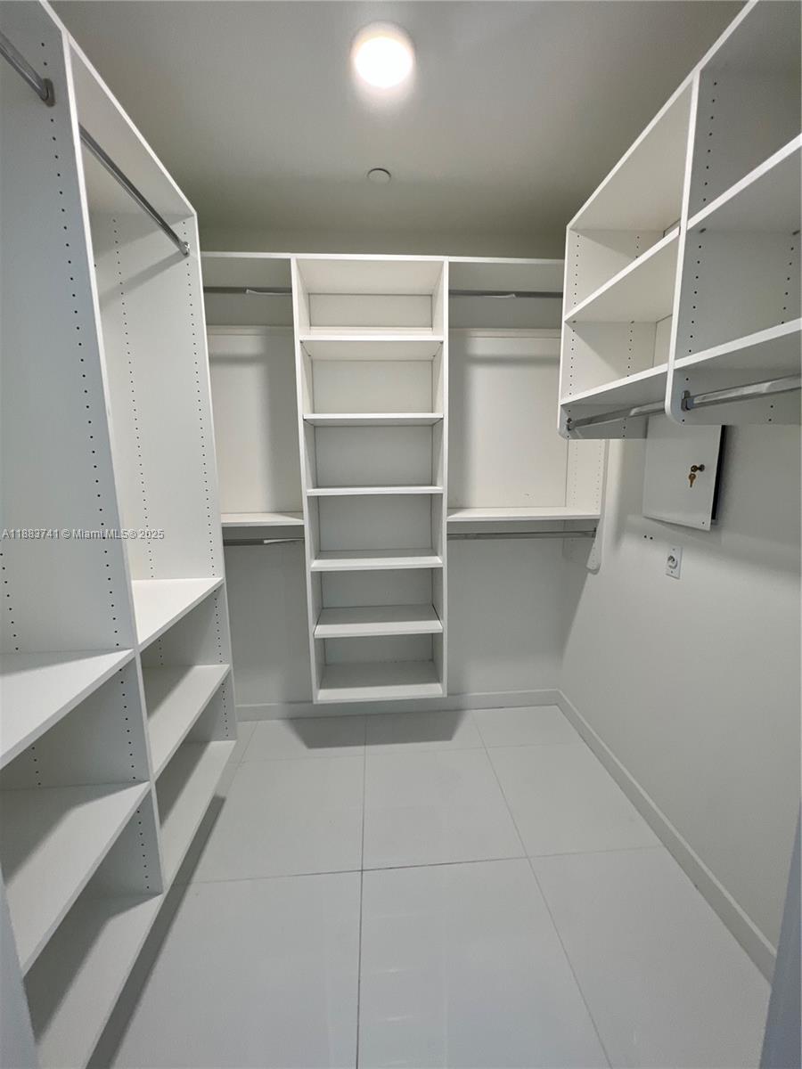 851 Northeast 1st Avenue, Unit 1208 Miami, FL 33132 - Photo 13 of 26 a view of walk in closet with empty racks