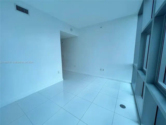a spacious bathroom with a bathtub sink mirror and toilet