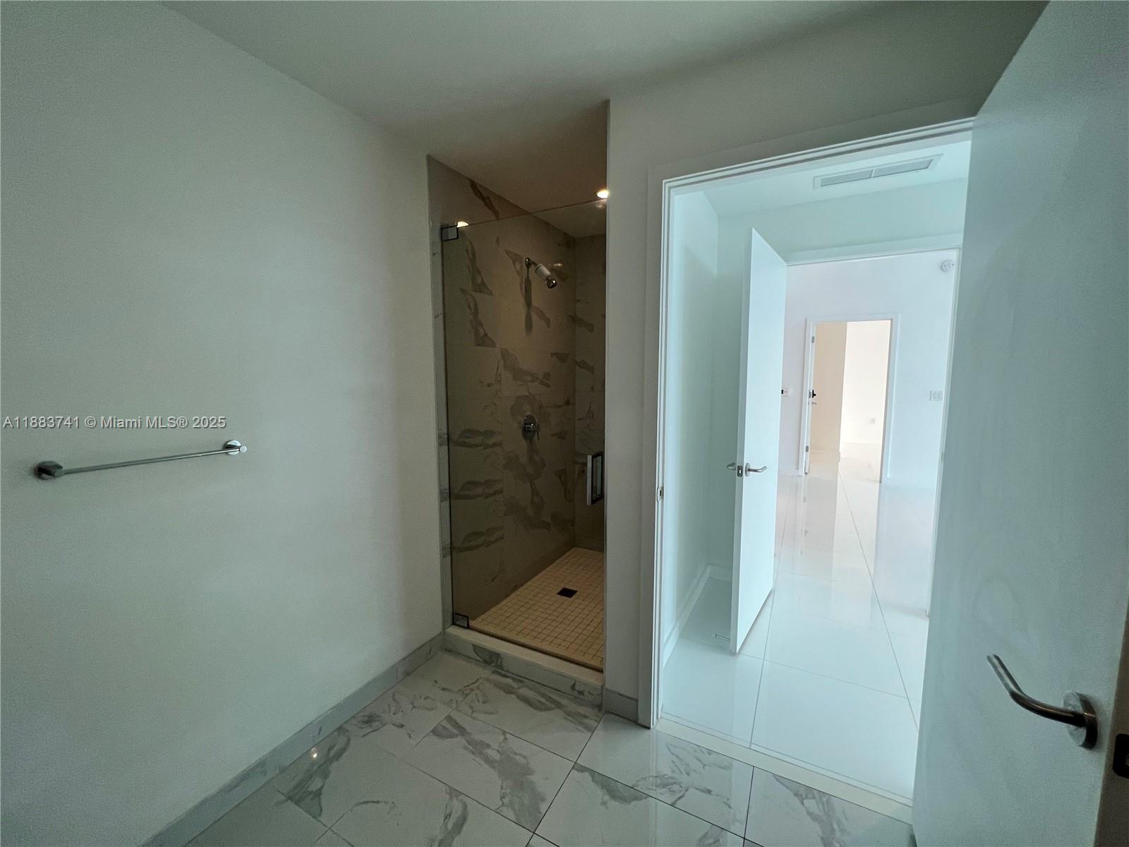 851 Northeast 1st Avenue, Unit 1208 Miami, FL 33132 - Photo 18 of 26 a bathroom with a glass shower door