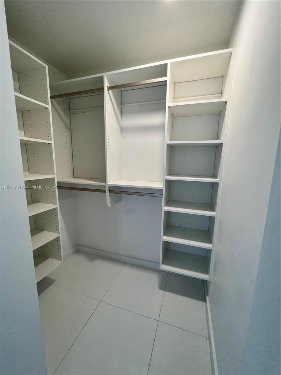 851 Northeast 1st Avenue, Unit 1208 Miami, FL 33132 - Photo 19 of 26 a view of walk in closet with empty racks