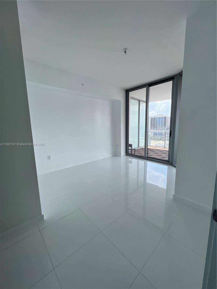 851 Northeast 1st Avenue, Unit 1208 Miami, FL 33132 - Photo 7 of 26 an empty room with windows