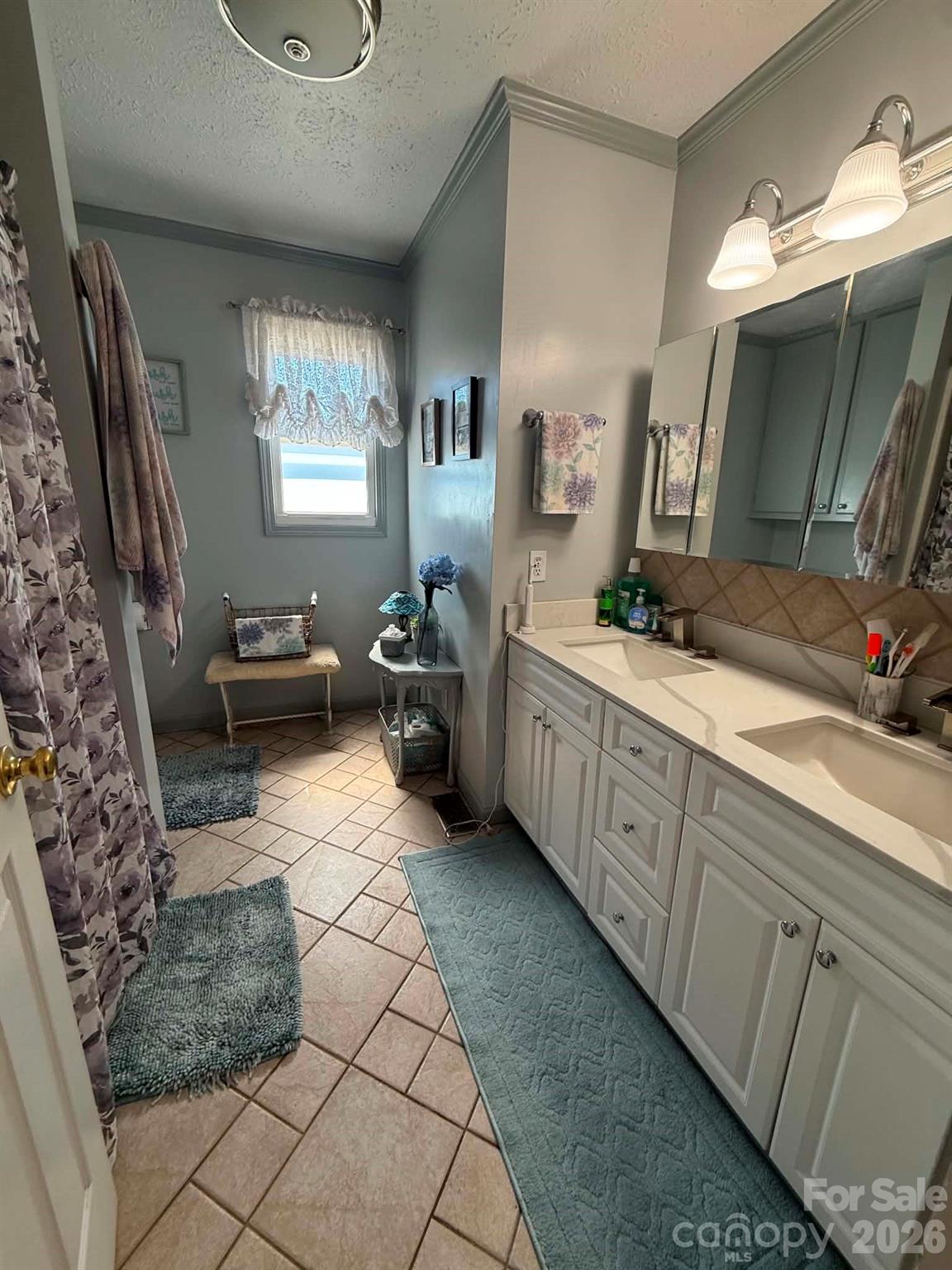 2121 Union Grove Road Lenoir, NC 28645 - Photo 16 of 38 a spacious bathroom with a double vanity sink a mirror and a shower