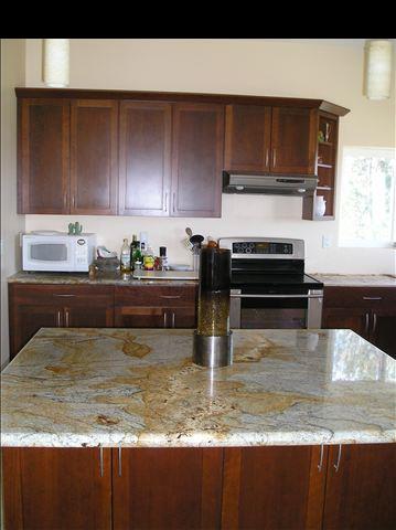 2748 Lower Kula Road Kula, HI 96790 - Photo 3 of 12 a kitchen with a sink a stove and cabinets