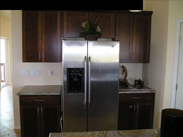2748 Lower Kula Road Kula, HI 96790 - Photo 4 of 12 a kitchen with a refrigerator and a sink