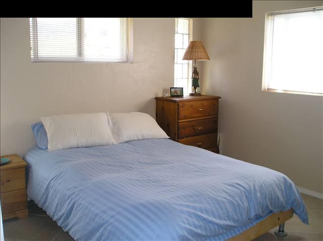 2748 Lower Kula Road Kula, HI 96790 - Photo 10 of 12 a bedroom with a bed and a window