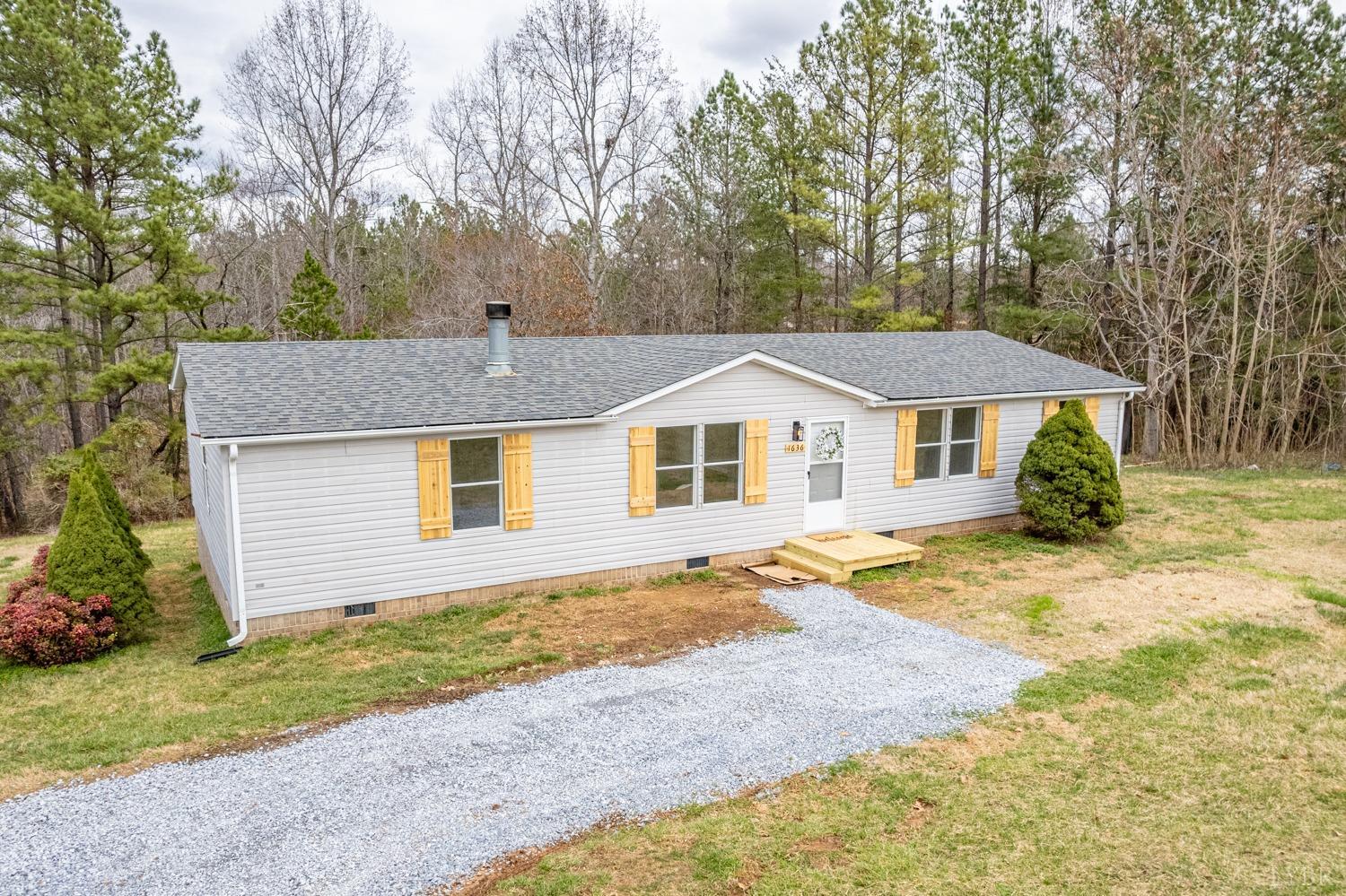 1636 Maddox Road Gladys, VA 24554 - Photo 1 of 54 a front view of a house with a yard and trees