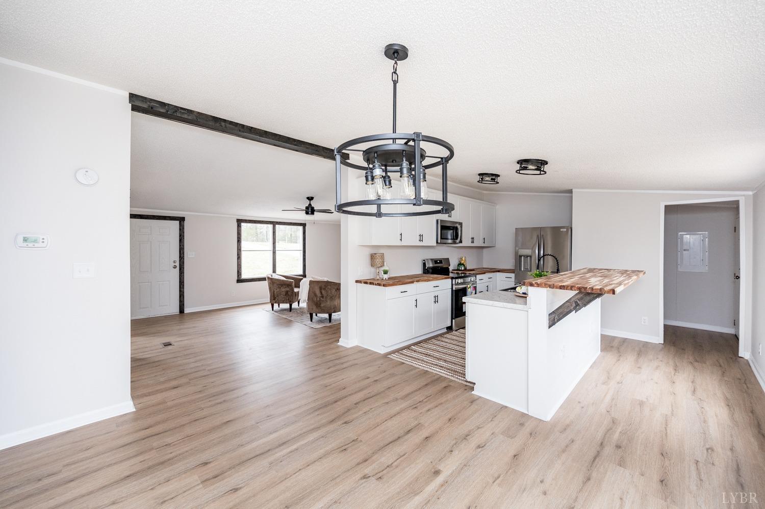 1636 Maddox Road Gladys, VA 24554 - Photo 12 of 54 a kitchen with sink cabinets and wooden floor
