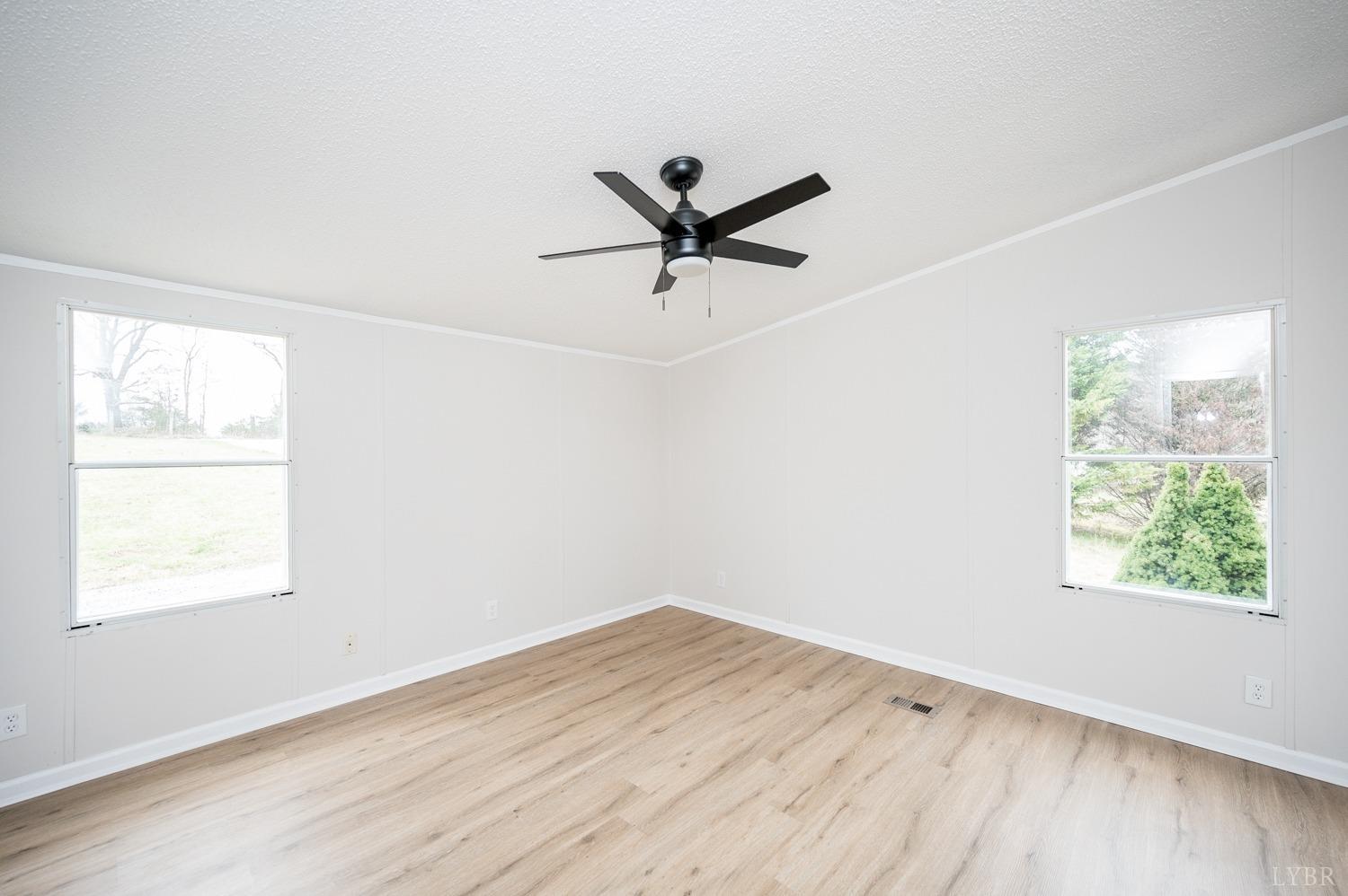 1636 Maddox Road Gladys, VA 24554 - Photo 16 of 54 an empty room with a window and a ceiling fan