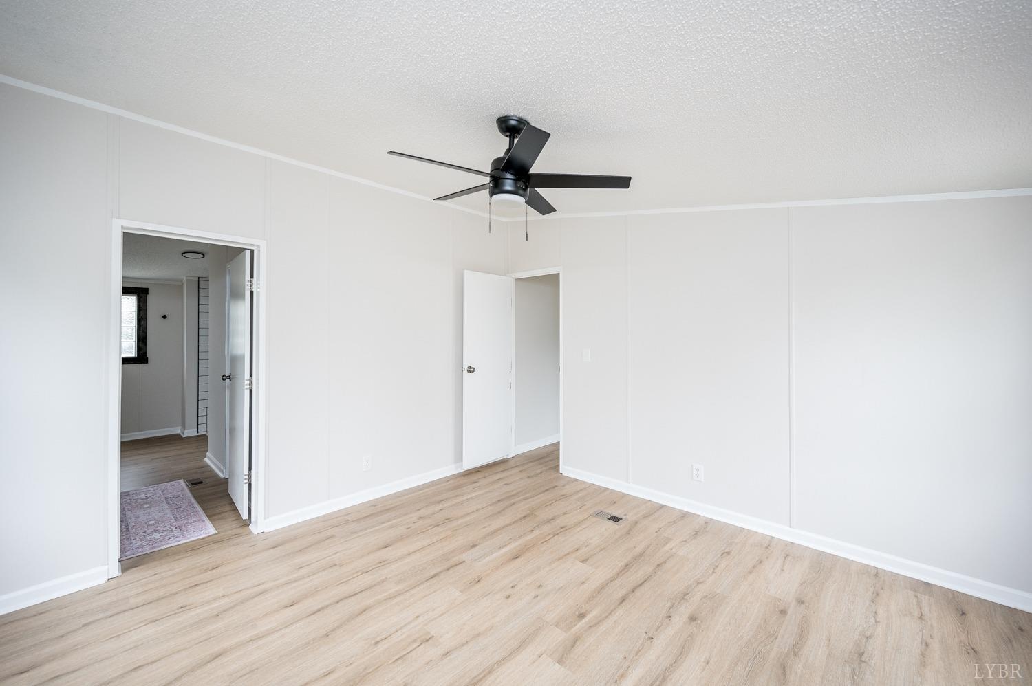 1636 Maddox Road Gladys, VA 24554 - Photo 17 of 54 a view of a room with wooden floor and a ceiling fan