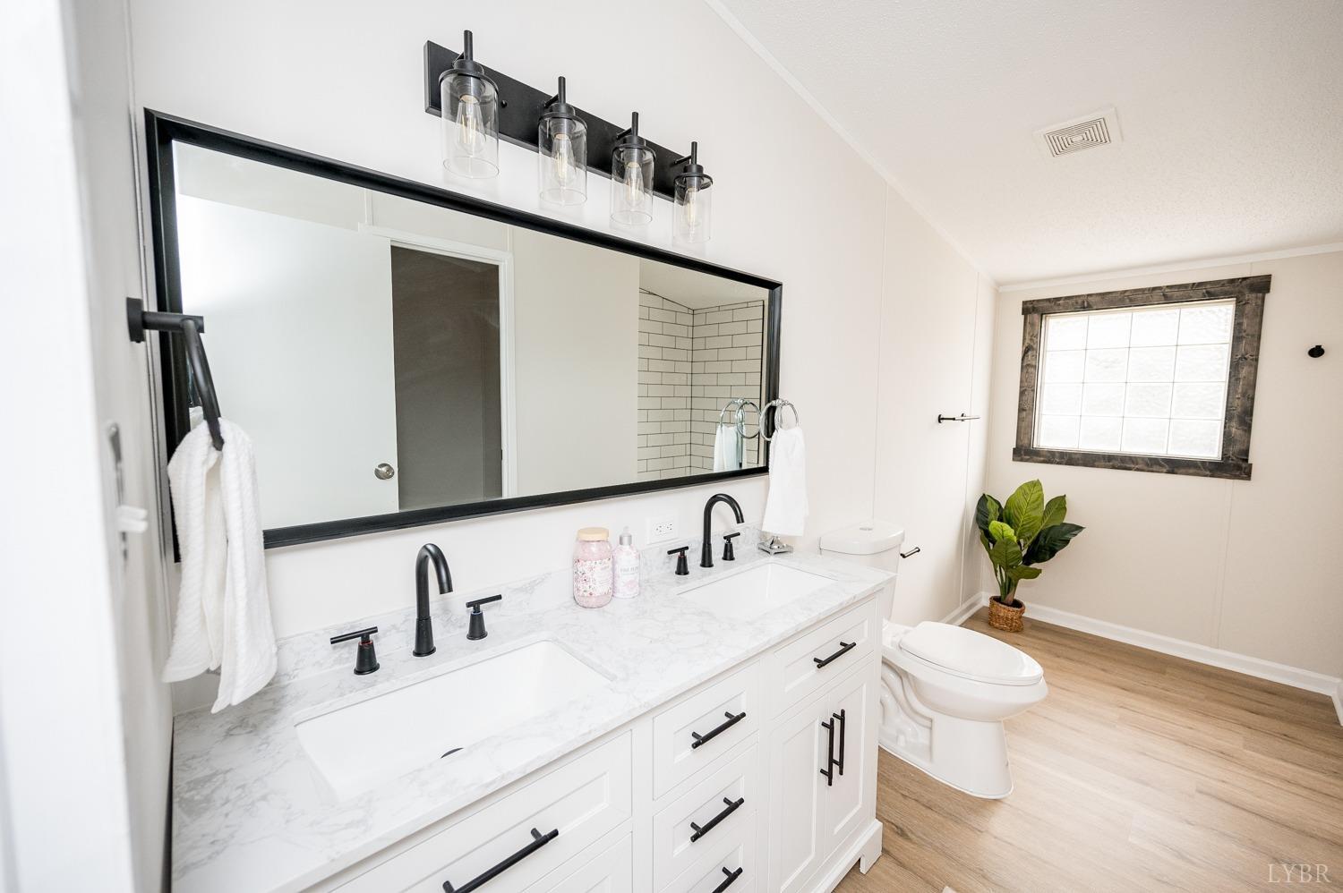 1636 Maddox Road Gladys, VA 24554 - Photo 18 of 54 a bathroom with a granite countertop sink and a mirror