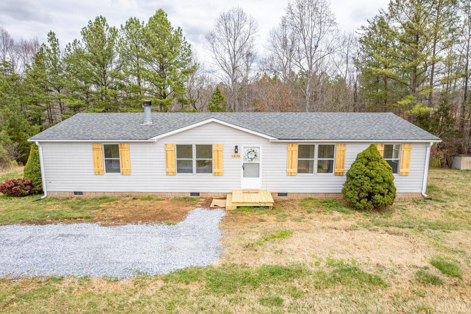 1636 Maddox Road Gladys, VA 24554 - Photo 2 of 54 a view of a yard in front of a house with large trees