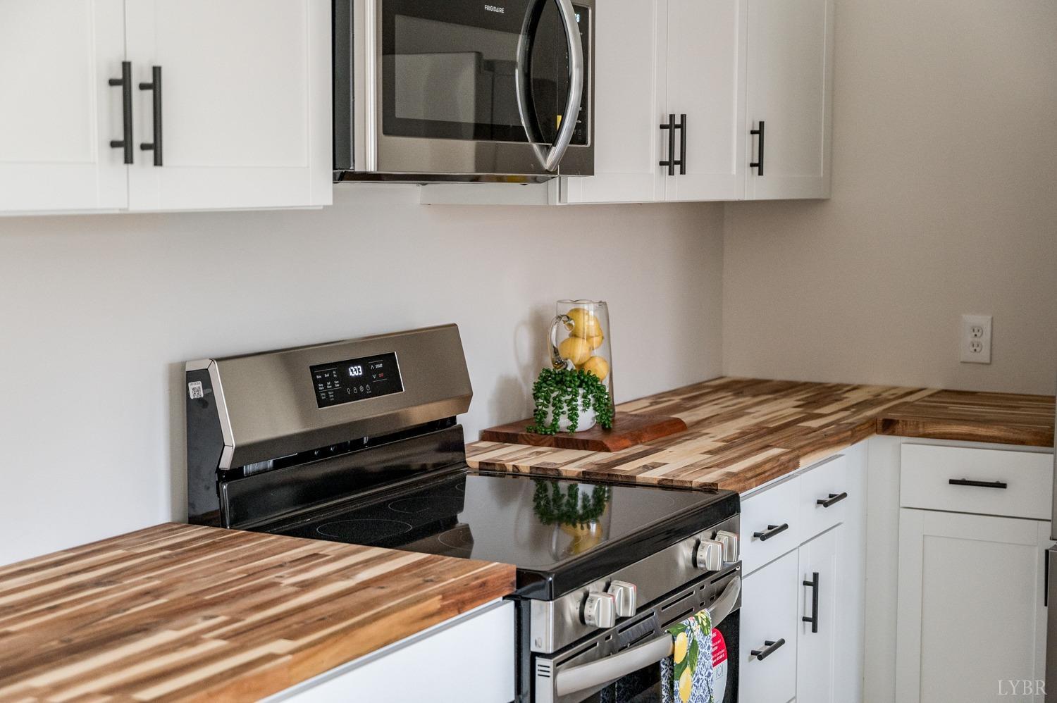 1636 Maddox Road Gladys, VA 24554 - Photo 34 of 54 a kitchen with stainless steel appliances a stove a microwave and cabinets