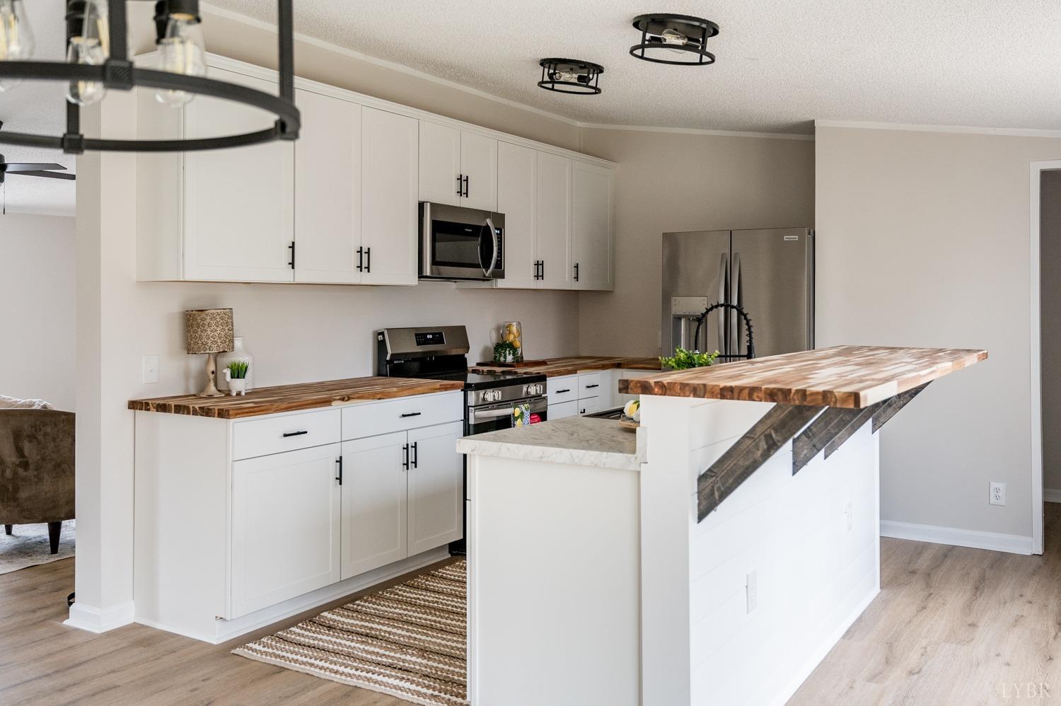 1636 Maddox Road Gladys, VA 24554 - Photo 40 of 54 a kitchen with a sink a stove and cabinets