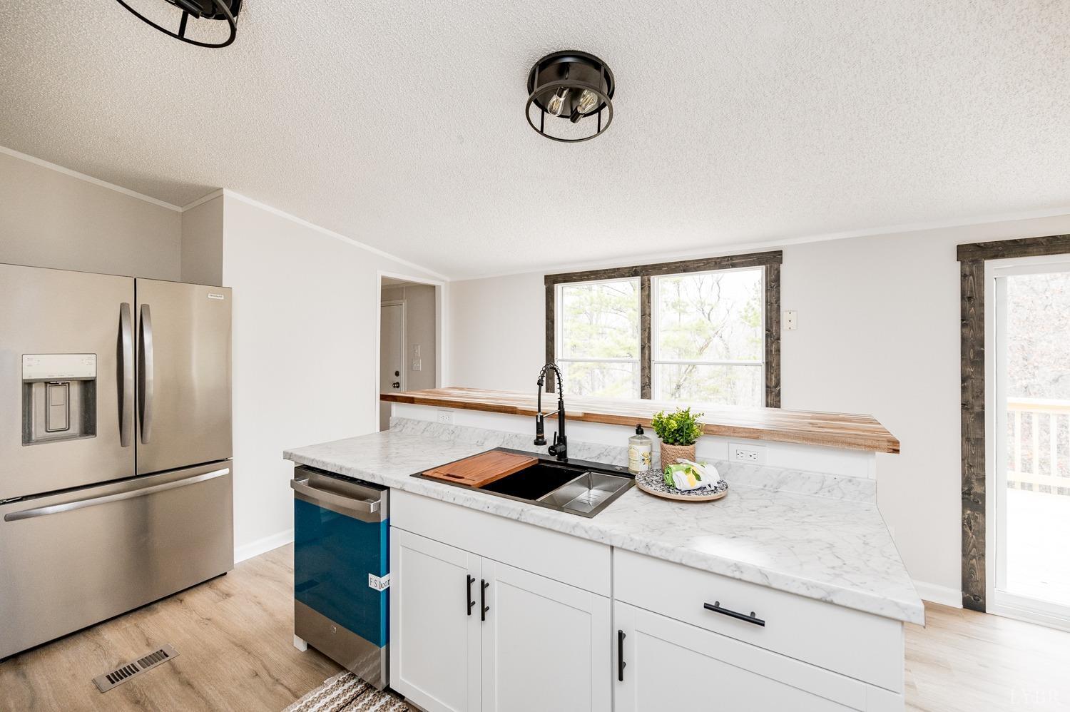 1636 Maddox Road Gladys, VA 24554 - Photo 7 of 54 a kitchen with a refrigerator and a sink