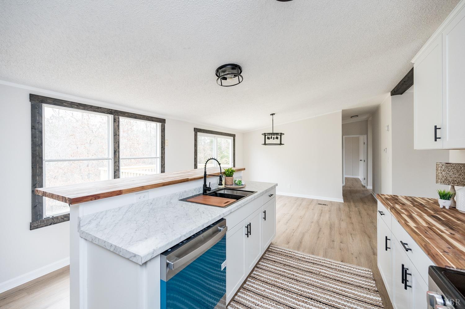 1636 Maddox Road Gladys, VA 24554 - Photo 8 of 54 a kitchen with stainless steel appliances granite countertop a sink and a stove