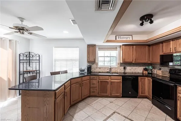 a kitchen with lots of counter space a sink and appliances