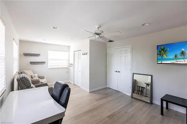 a living room with furniture and a wooden floor