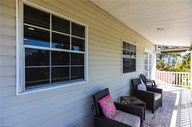a view of a house with a large window and a chair