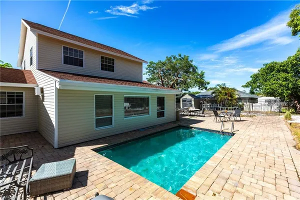 a view of a swimming pool with lounge chair