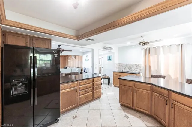 a kitchen with stainless steel appliances granite countertop a refrigerator and a sink