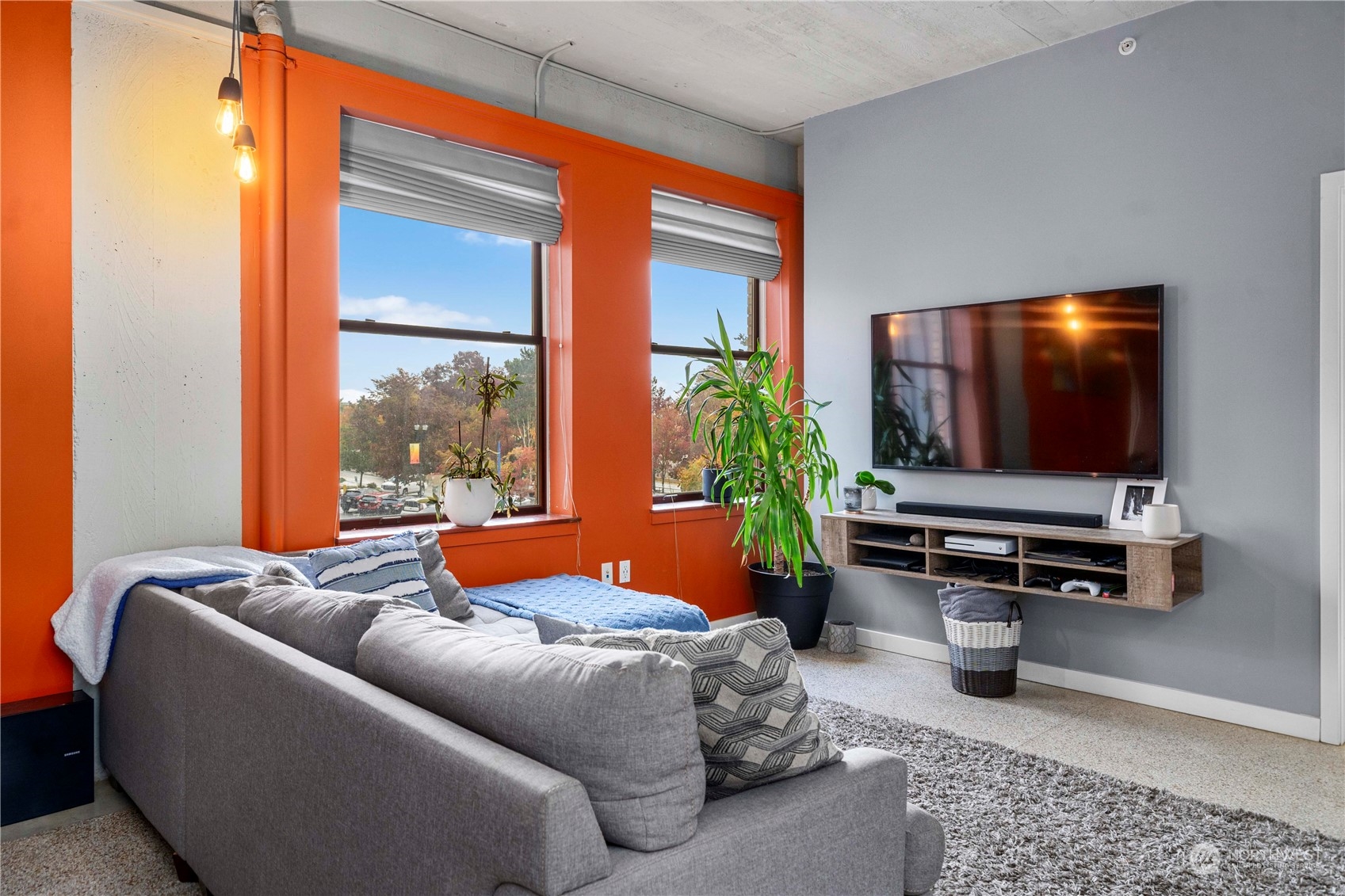 744 Market Street, Unit 302 Tacoma, WA 98402 - Photo 6 of 28 a living room with furniture and a flat screen tv