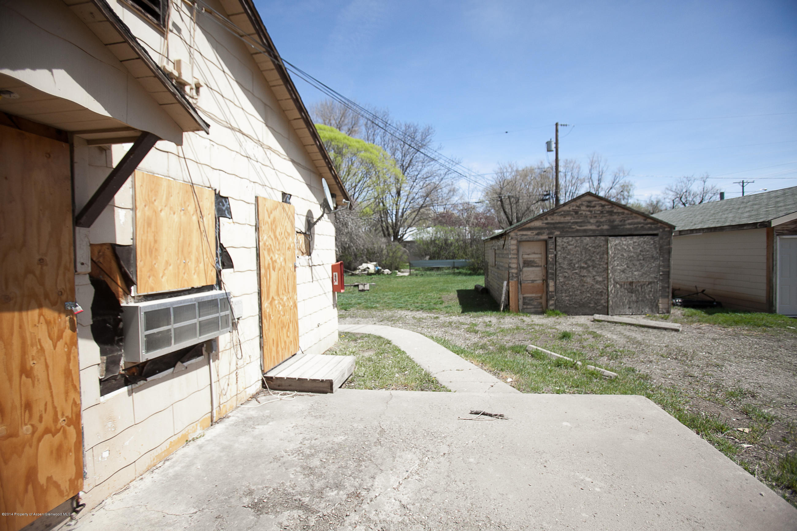 132 Ray Avenue Rifle, CO 81650 - Photo 4 of 10 a front view of a house with a yard and garage