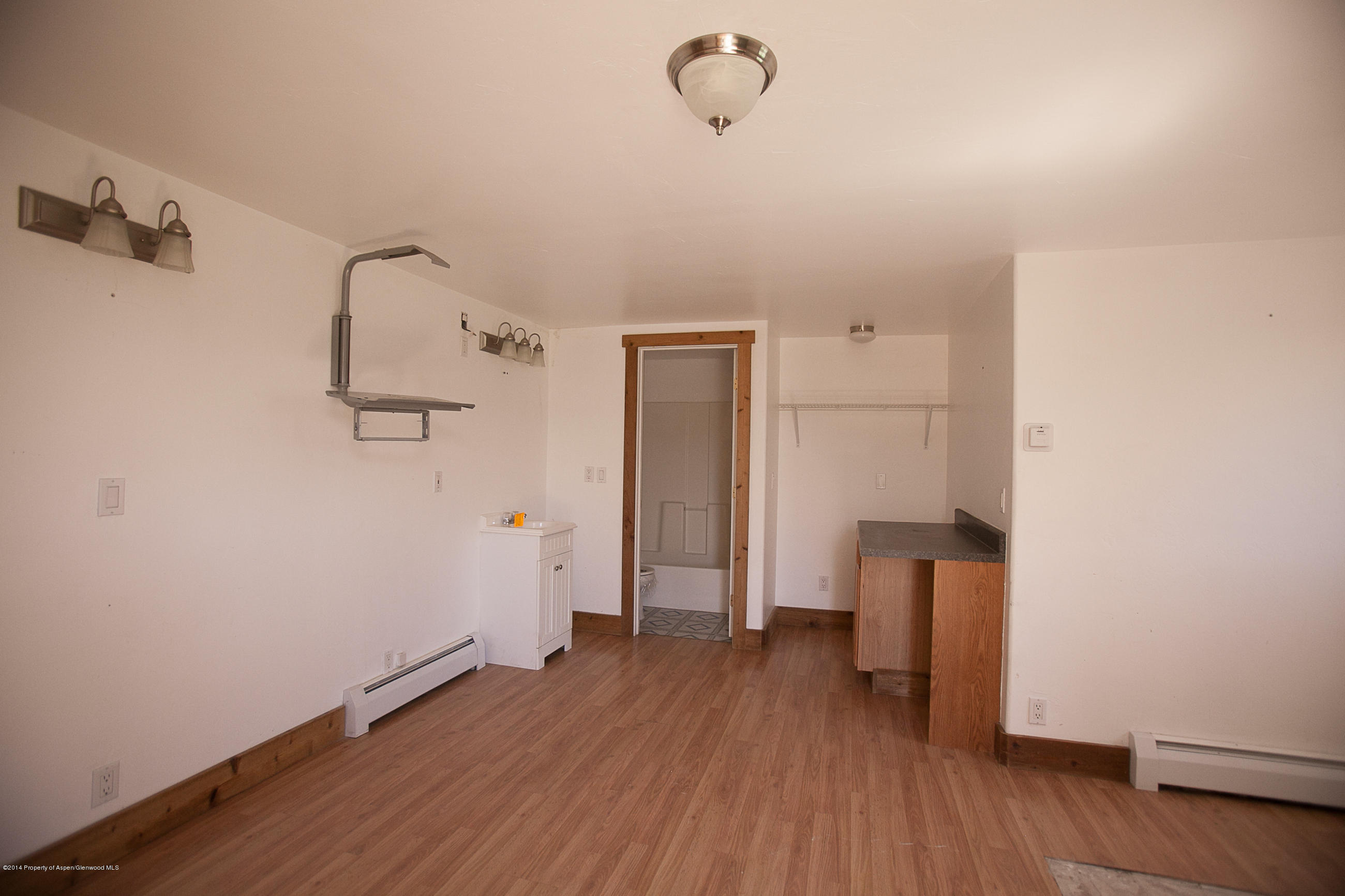 132 Ray Avenue Rifle, CO 81650 - Photo 6 of 10 a view of empty room with wooden floor