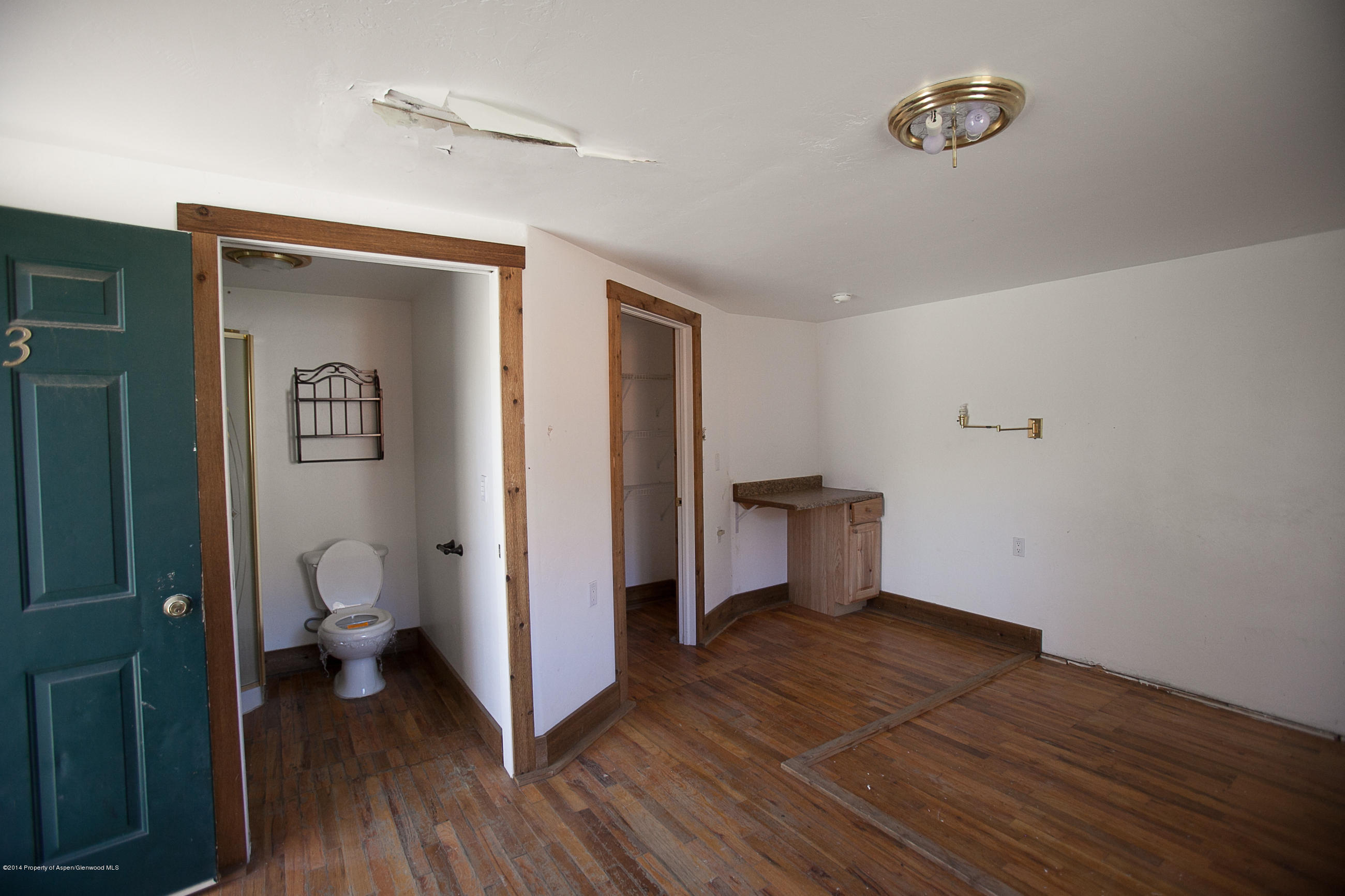 132 Ray Avenue Rifle, CO 81650 - Photo 8 of 10 a view of a room with wooden floor and a bathroom