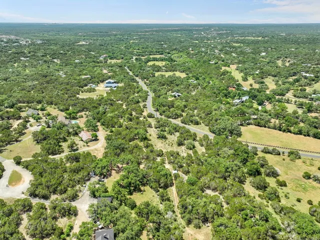 a view of a green field with lots of bushes