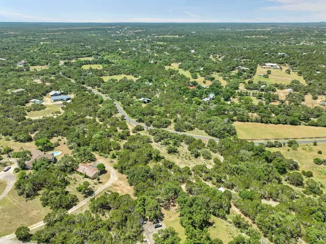 a view of a green field with lots of bushes