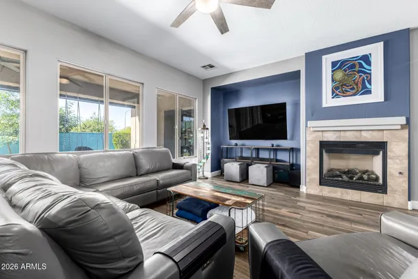 a kitchen with stainless steel appliances granite countertop a stove top oven a refrigerator a sink and dishwasher with wooden floor