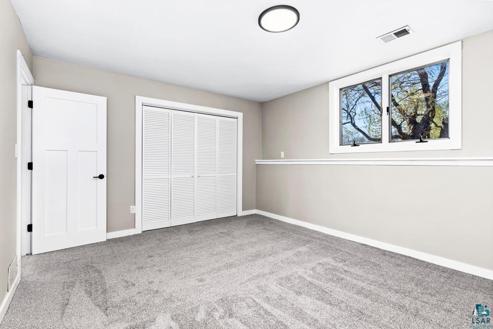 1148 Shoreview Road Two Harbors, MN 55616 - Photo 20 of 48 Unfurnished bedroom featuring carpet flooring and a closet
