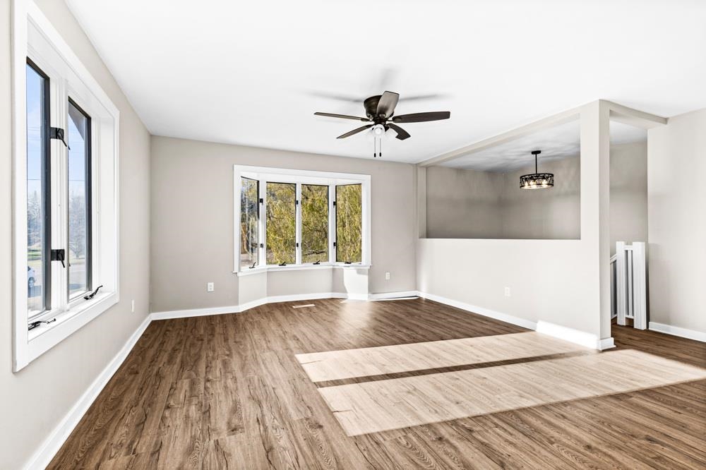 1148 Shoreview Road Two Harbors, MN 55616 - Photo 9 of 48 Spare room featuring hardwood / wood-style floors and ceiling fan with notable chandelier