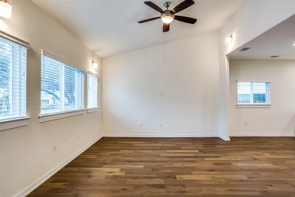 a view of a room with wooden floor and window