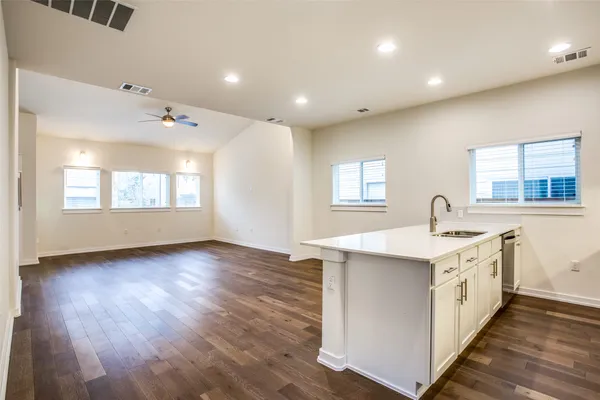a view of a kitchen with wooden floor and sink