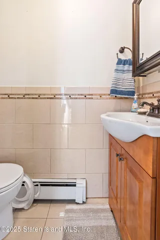 a bathroom with a sink a toilet and a mirror