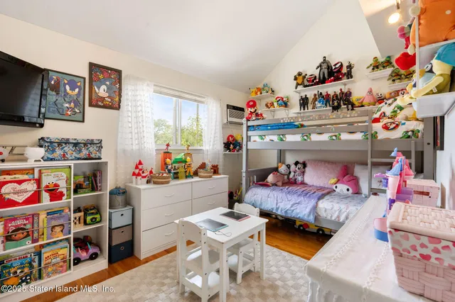 a bedroom with furniture and a baby crib