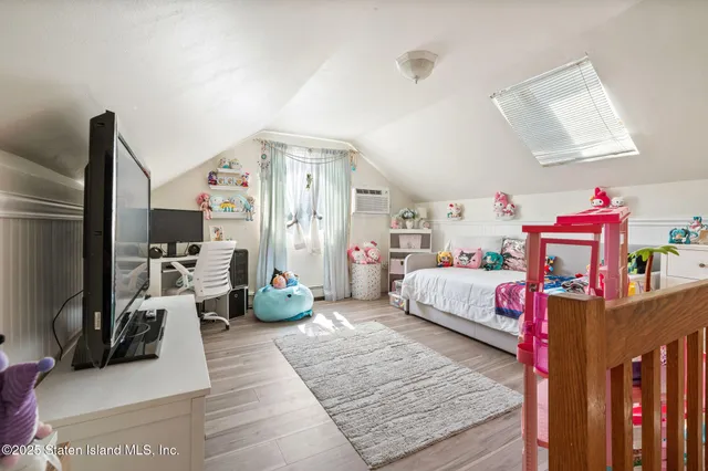 a bedroom with furniture and a flat screen tv