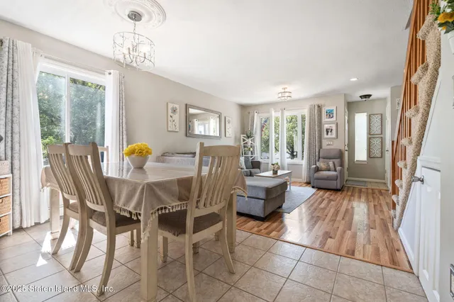a view of a dining room with furniture and chandelier