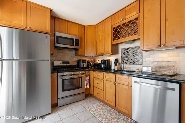 a kitchen with stainless steel appliances granite countertop a refrigerator sink and cabinets